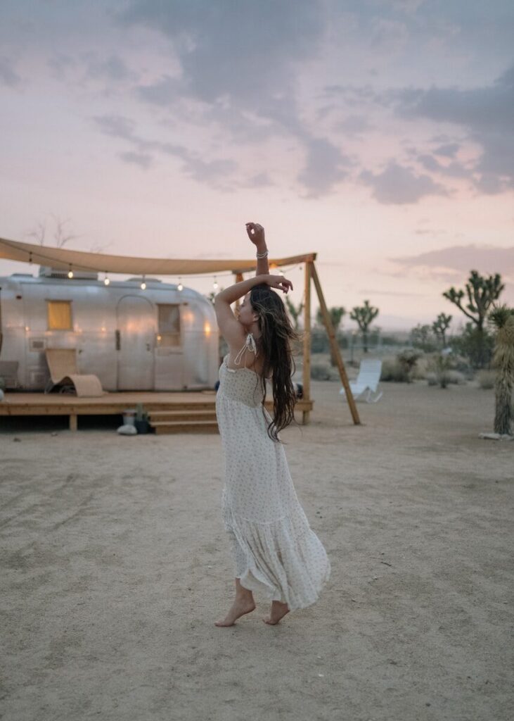 woman raising her both arms