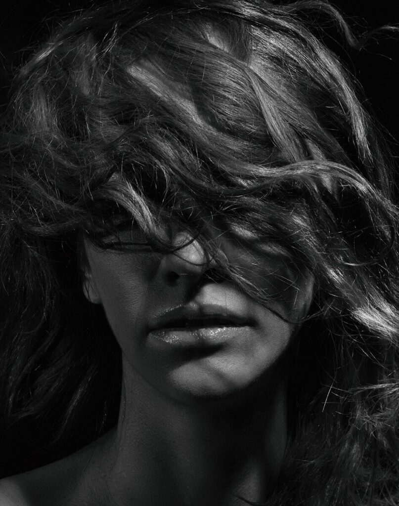 a woman with her hair blowing in the wind